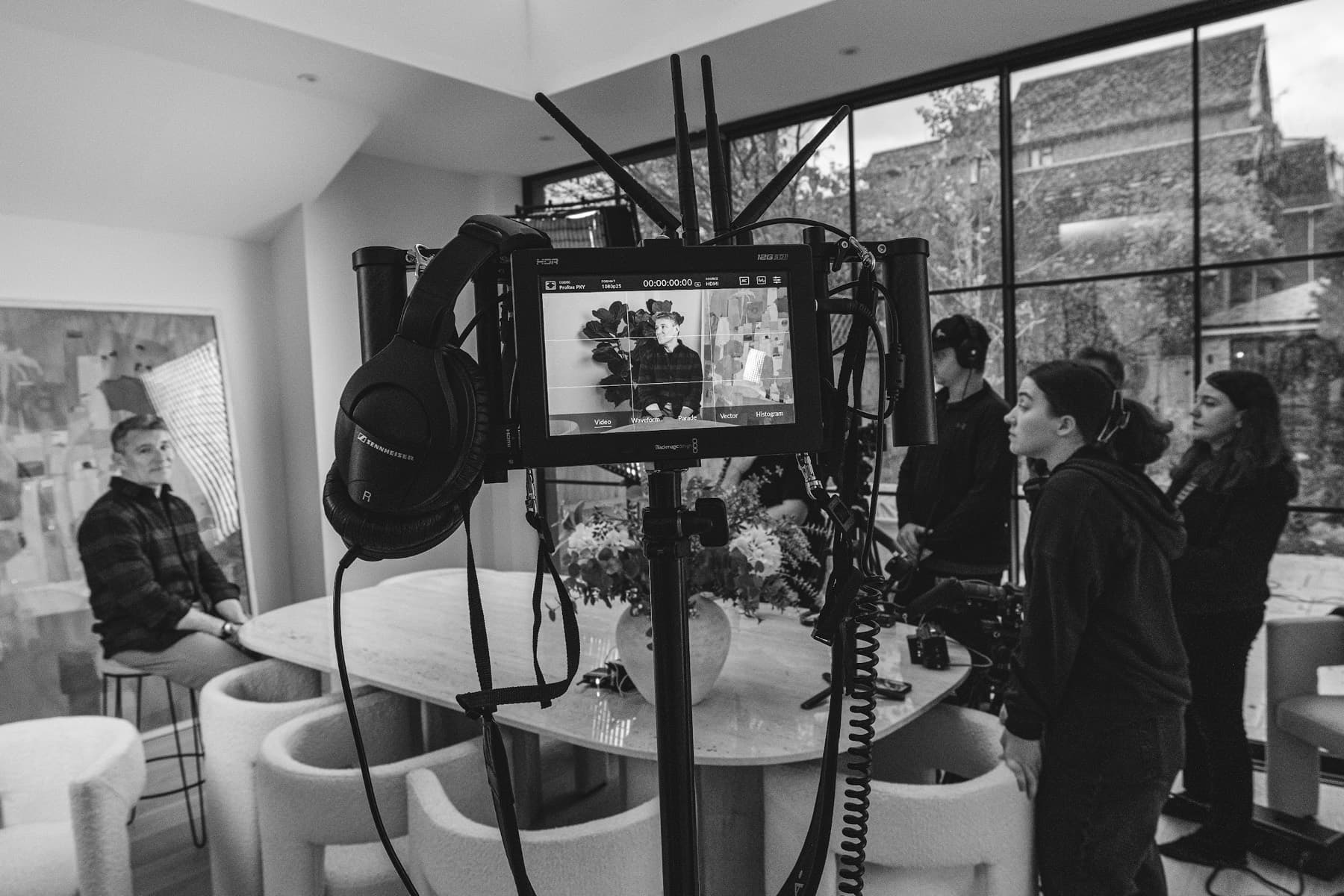 Behind the scenes — camera, monitor and crew mid-setup on a location shoot
