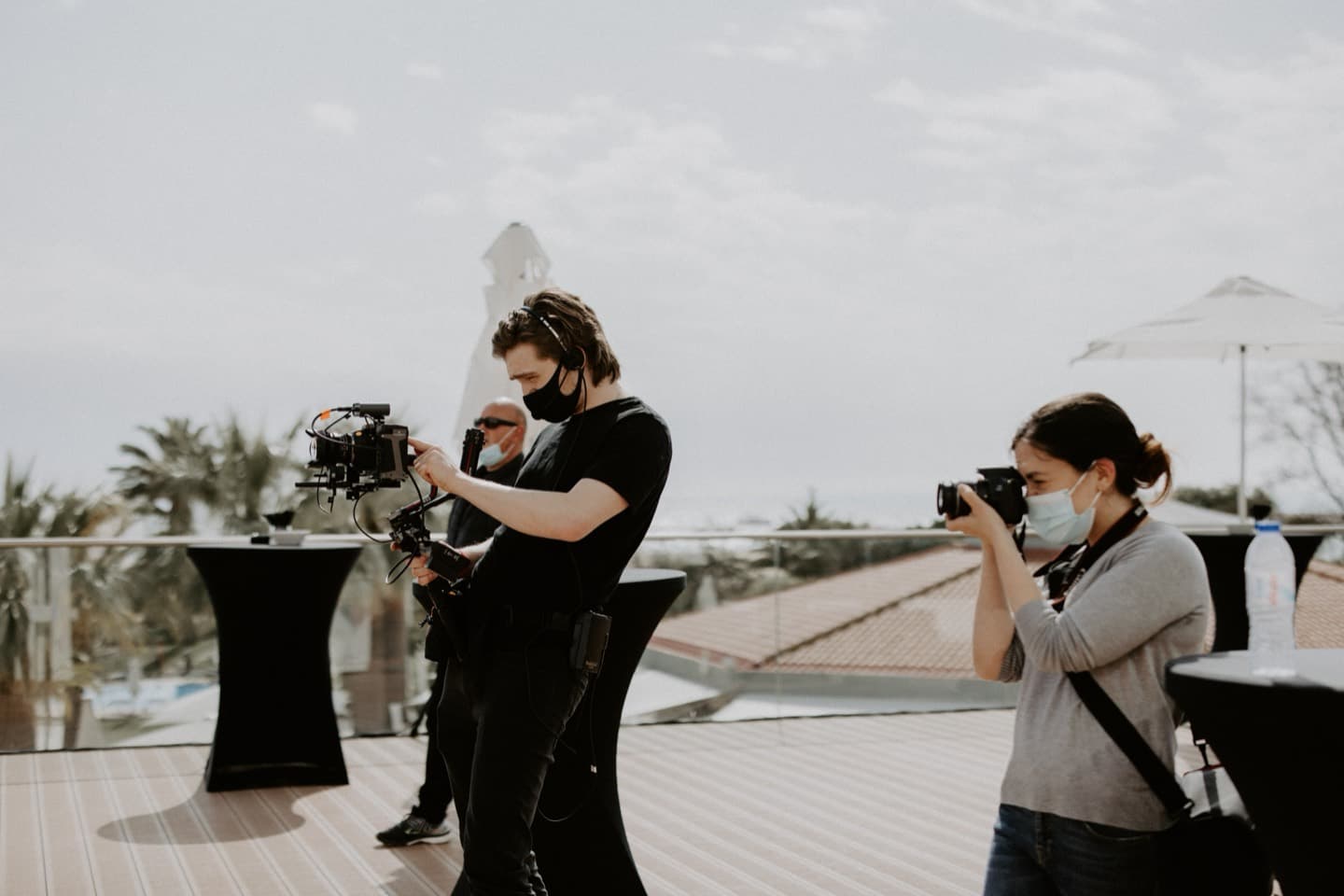Two of the crew shooting outside the venue between ceremony moments