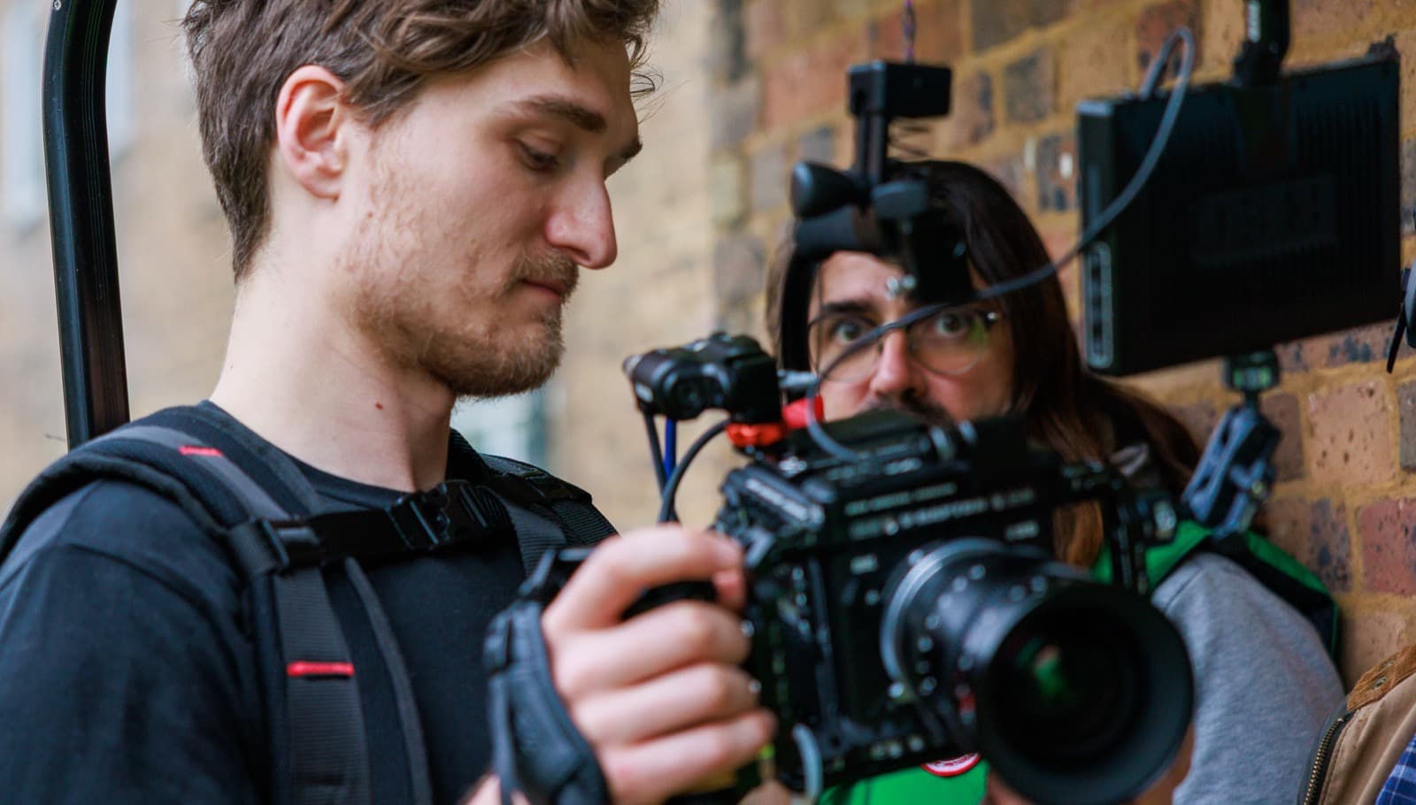 A camera operator checking the build before a take