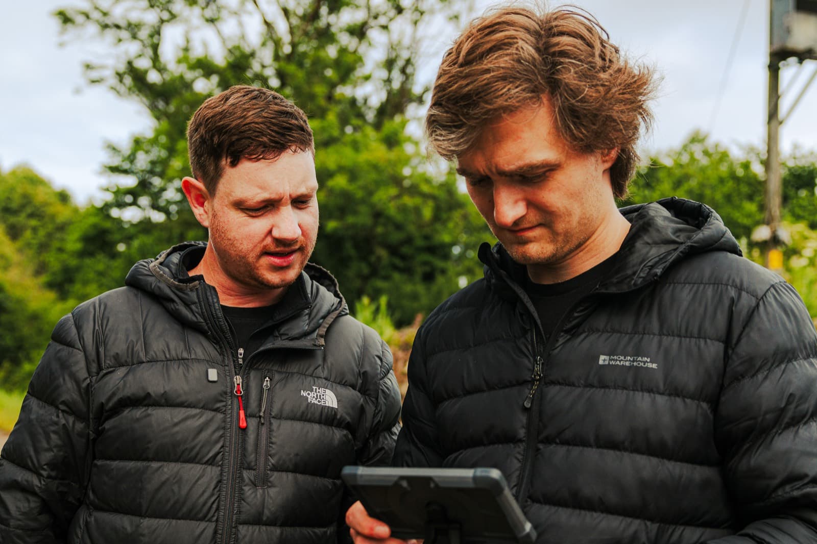 Jack Hobbs and Ben Roberts checking a take on a monitor outdoors