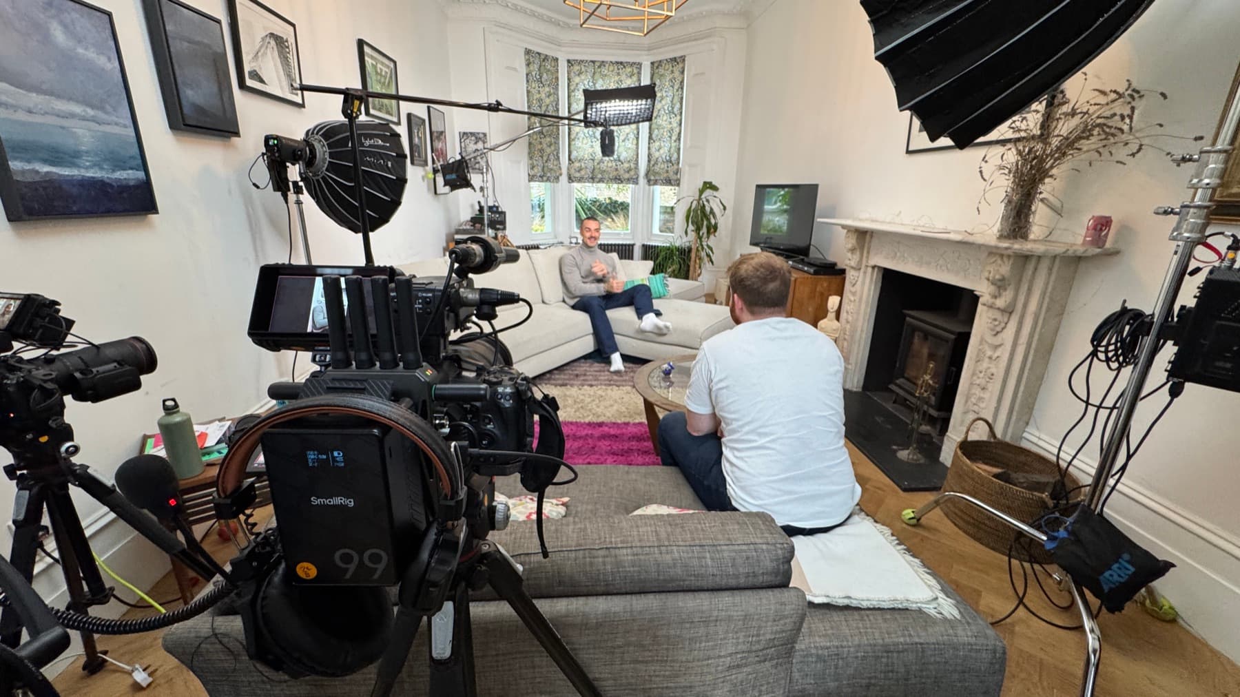 A sitting room turned round for an interview, lighting through the bay window and the camera set low behind the sofa