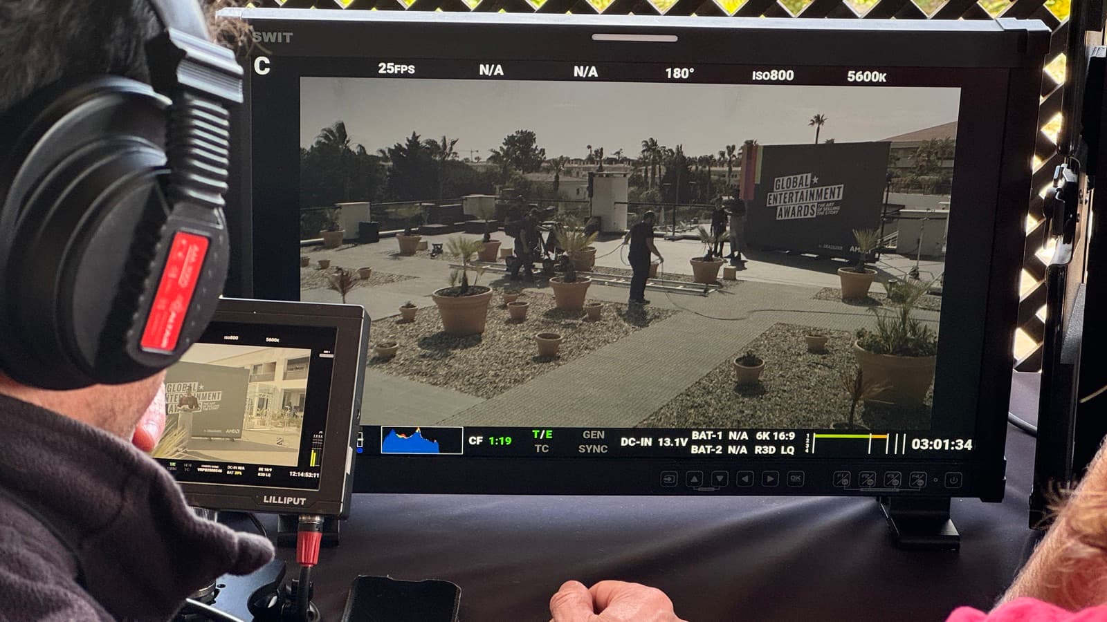 Watching the frame back on a director's monitor, camera settings and timecode running beneath it