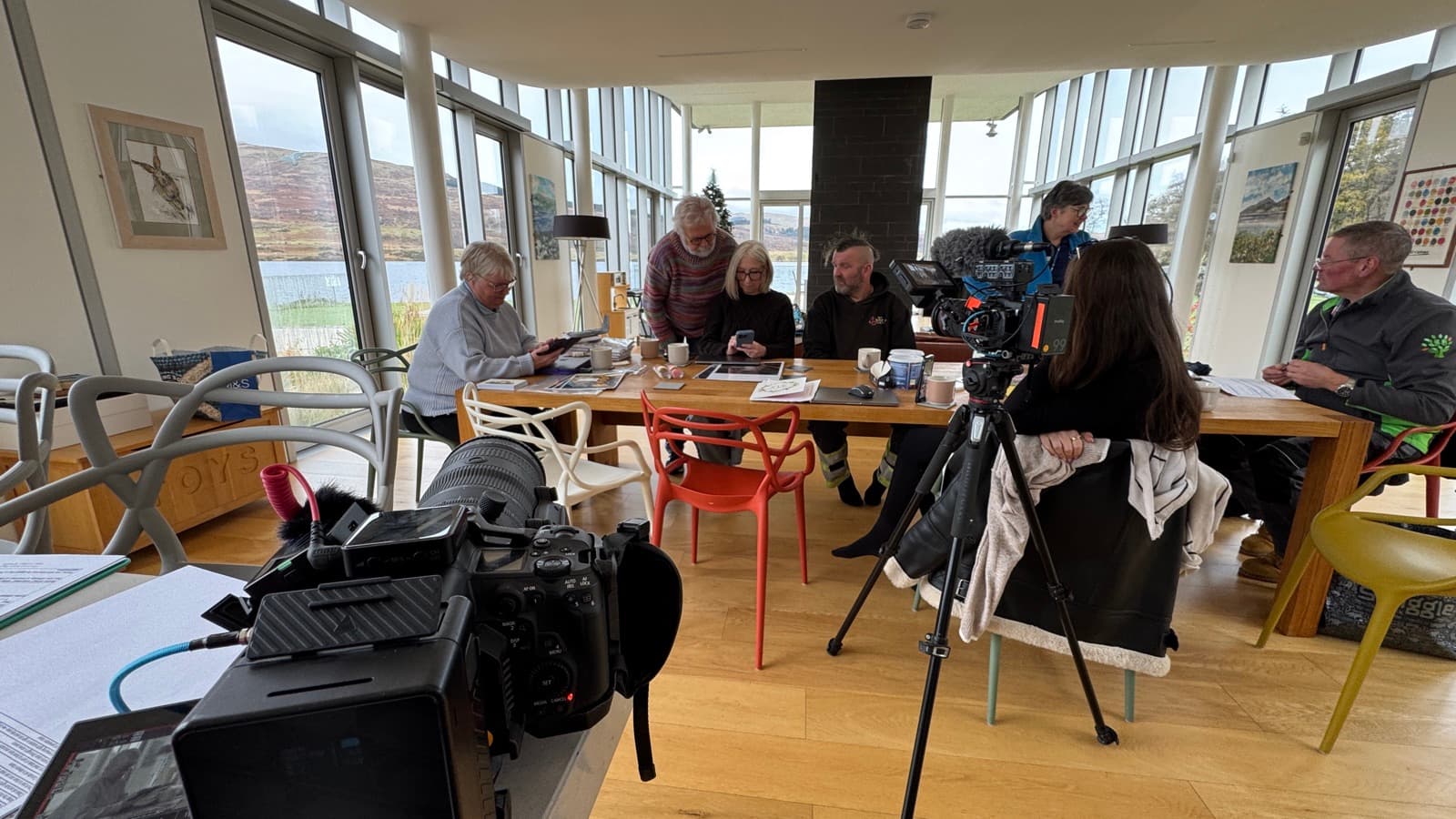 Covering a round-table meeting in a glass room above the water, camera and boom in the foreground