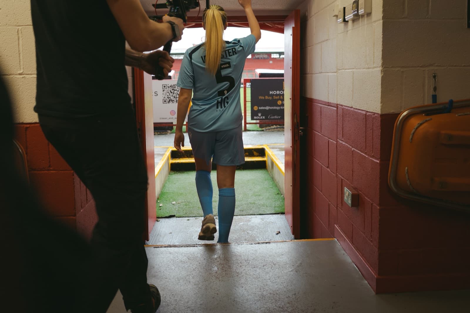 Following a player out through the tunnel to the pitch, the operator moving with them