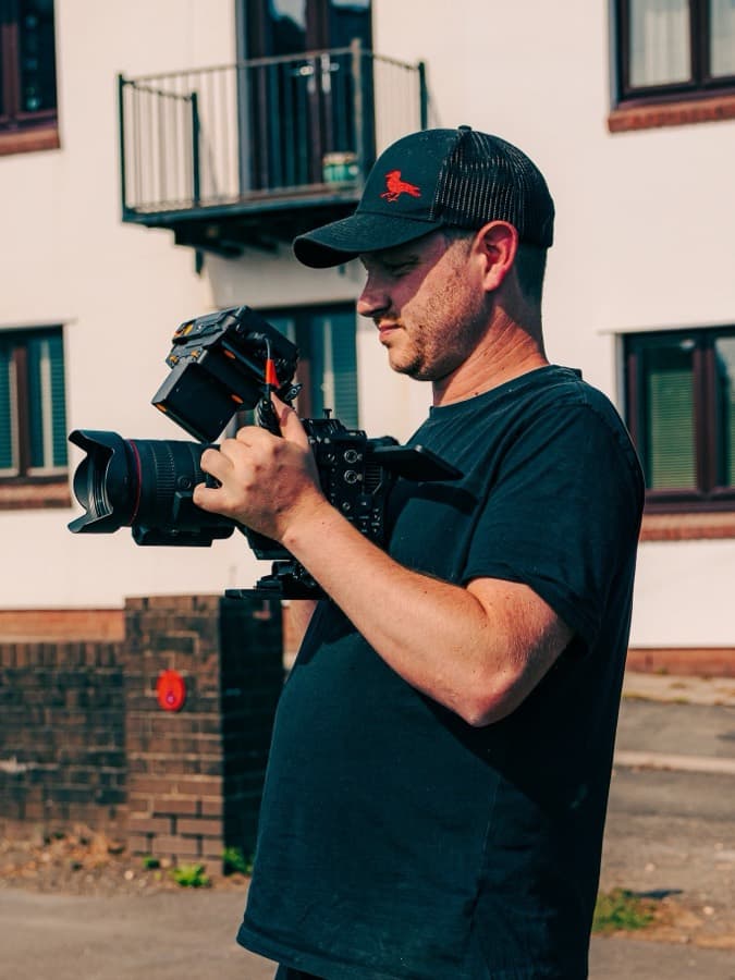 Ben Roberts shouldering a built-up camera on a location shoot